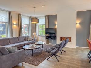 a living room with a couch and a table at Dune Design 38 in Colijnsplaat