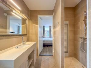 a bathroom with a sink and a shower at Dune Design 38 in Colijnsplaat +32 photos