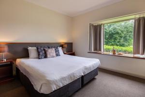 a bedroom with a large bed and a window at Harrigan's Hunter Valley in Pokolbin +67 photos