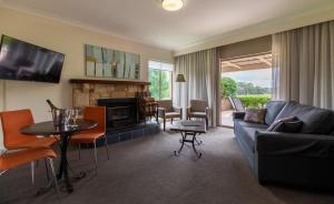 a living room with a couch and a table at Harrigan's Hunter Valley in Pokolbin