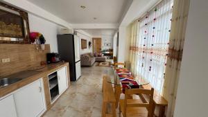 a kitchen with a dining table and a refrigerator at Valle Sagrado in Coya