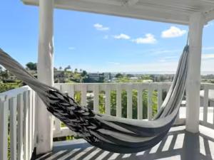 a hammock on the porch of a house at 2BR Oceanview Villas - Slice of Paradise, Central Suva in Suva