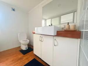 a white bathroom with a toilet and a sink at 2BR Oceanview Villas - Slice of Paradise, Central Suva in Suva +21 photos