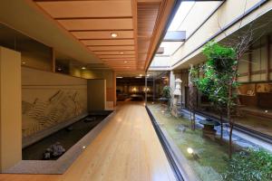 a hallway of an office building with a long wooden floor at Wakamatsu Hot Spring Resort in Hakodate +149 photos