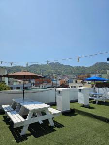 a picnic table and an umbrella on a roof at AnJin's Guest House in Mokpo