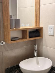 a bathroom with a white sink and a mirror at Apart Zona Paula in San Juan +40 photos