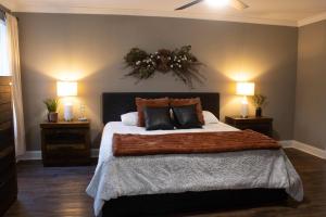a bedroom with a large bed with two night stands at Peach State Hideaway The Columbus Escape in Columbus