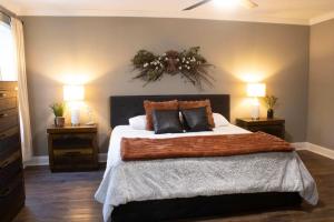 a bedroom with a large bed with two night stands at Peach State Hideaway The Columbus Escape in Columbus