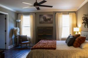 a bedroom with a bed and a ceiling fan at Peach State Hideaway The Columbus Escape in Columbus +46 photos