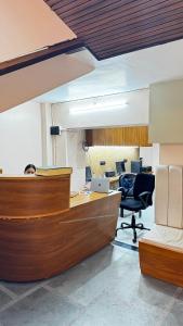 an office with a desk and two desks and chairs at Hotel Chhaya in Rishīkesh +33 photos