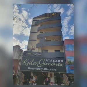 a tall building with a sign in front of it at Refugio Centrico in Ciudad del Este