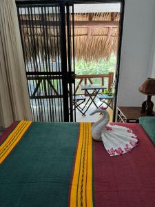 a bed with a white swan on it in a room at Villas Mercedes in Zihuatanejo +34 photos