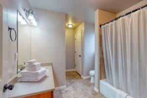 a bathroom with a sink and a shower with towels at Sunset Vista in Garden City +31 photos