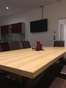 a large wooden table with a red candle on top at Appartement Feinsinn in Westendorf