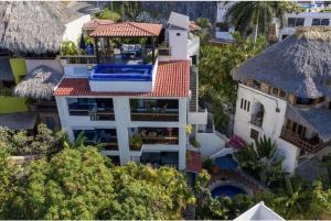 an overhead view of a white building with a red roof at Villas Mimosa at La Ropa Beach in Zihuatanejo