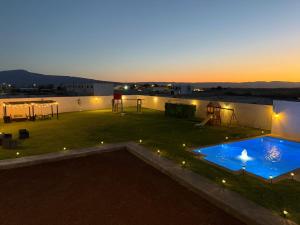 a view of a patio with a swimming pool at sunset at Departamentos Aremay in Cuatrociénegas de Carranza