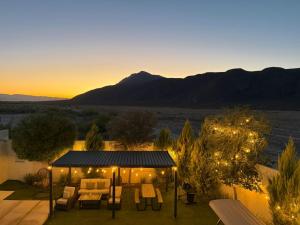 a patio with a gazebo with chairs and lights at Departamentos Aremay in Cuatrociénegas de Carranza