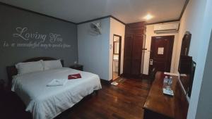 a bedroom with a bed with a red box on it at DaViKa Vientiane Hotel in Vientiane +8 photos