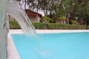a water fountain in front of a swimming pool at Pousada Vila Pequi in Barreirinhas +109 photos