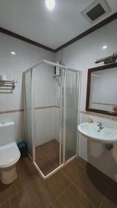 a bathroom with a shower and a toilet and a sink at DaViKa Vientiane Hotel in Vientiane
