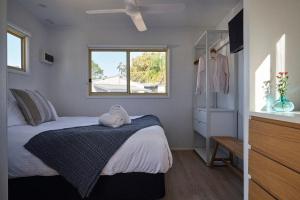 a small bedroom with a bed and a window at The Mook Mollymook in Mollymook +61 photos