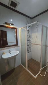 a bathroom with a shower and a sink at DaViKa Vientiane Hotel in Vientiane