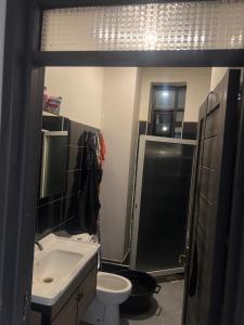 a bathroom with a sink and a toilet and a shower at AJ Space in Kampala