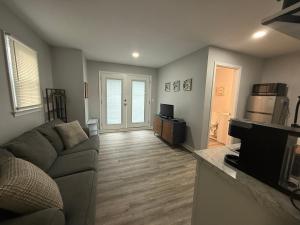 a living room with a couch and a television at Cozy and Chic Burlington Retreat in Burlington