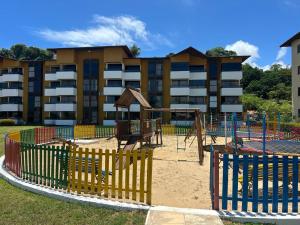 a playground in front of a apartment building at GAVOA Beach FLAT in Água Boa