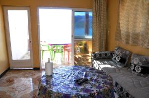 a living room with a table and a couch at Magic View in Bine el Ouidane