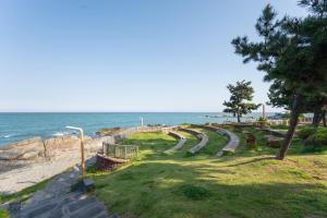 a park on the beach with the ocean in the background at Onseul Pension Busan in Busan +7 photos