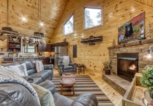 a living room with leather furniture and a fireplace at Bear Bottom View in Sevierville