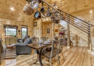 a dining room and living room in a log cabin at Bear Bottom View in Sevierville