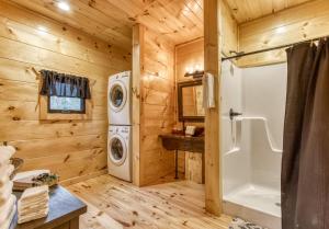 a log cabin bathroom with a washer and dryer at Bear Bottom View in Sevierville +32 photos