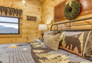 a bedroom with a bed and a window at Bear Bottom View in Sevierville