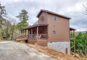 a large wooden house with a large garage at Bear Bottom View in Sevierville