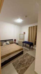 a bedroom with a bed and a table in it at Sharjah Room in Sharjah