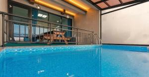 a large swimming pool in a building at Gaza Spa Pool Villa Yeosu in Yeosu