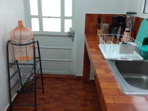 a kitchen with a counter with a shelf next to a sink at Gran Tonantzin in San Martín de las Pirámides +45 photos