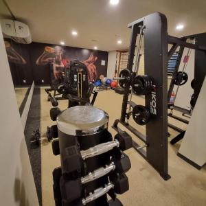 a room with a gym with a camera and a drum at risorte eco carneiros in Tamandaré