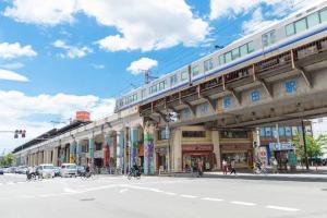 a train on a bridge over a city street at 十度-jude- in Osaka