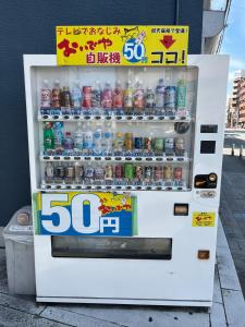 a vending machine filled with bottles of soda at 十度-jude- in Osaka