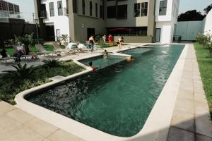 a pool in a building with people playing in it at Luxury Skyline Apartment with pool, city views & volcano views in El Rodeo