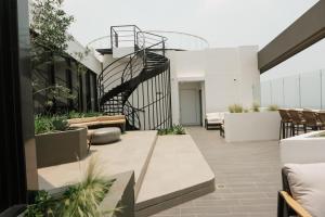 a patio with a spiral staircase on a building at Luxury Skyline Apartment with pool, city views & volcano views in El Rodeo