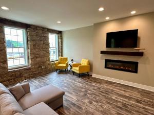 a living room with a couch and a fireplace at Grand River Suite in Bellevue