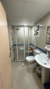 a bathroom with a shower and a toilet and a sink at Sharjah Room in Sharjah +17 photos