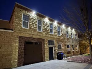 a brick building with a garage at night at Grand River Suite in Bellevue +5 photos