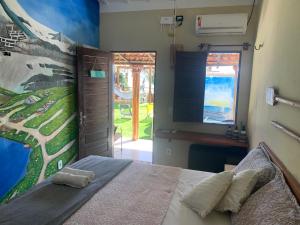 a bedroom with a bed and a painting on the wall at Mirante da Lua Residence in Aracati +44 photos