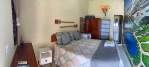 a bedroom with a bed and a painting on the wall at Mirante da Lua Residence in Aracati