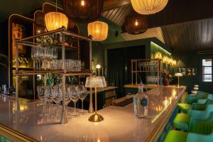 a bar with a lot of wine glasses and lights at Satri House Hotel in Luang Prabang